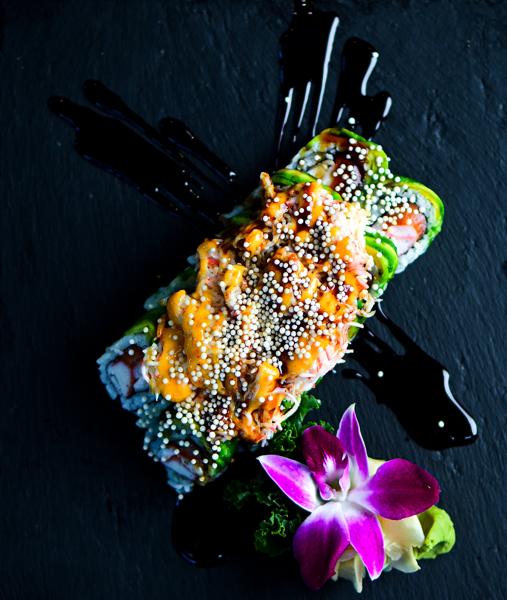 Dragon Roll (eel + avocado on top, sauce drizzle)